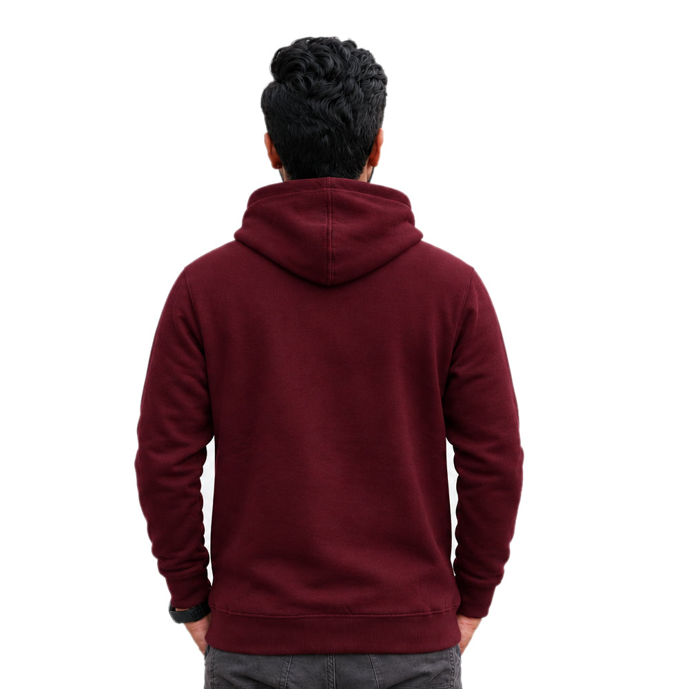 A man viewed from behind wearing a maroon hooded sweatshirt and gray pants against a plain white background.